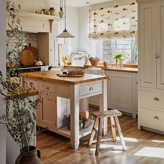 Cream and wood butcher's block style island in a country kitchen