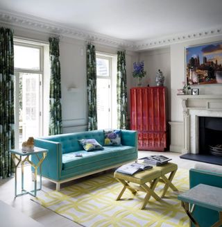 Colorful living room with blue sofa and patterned curtains