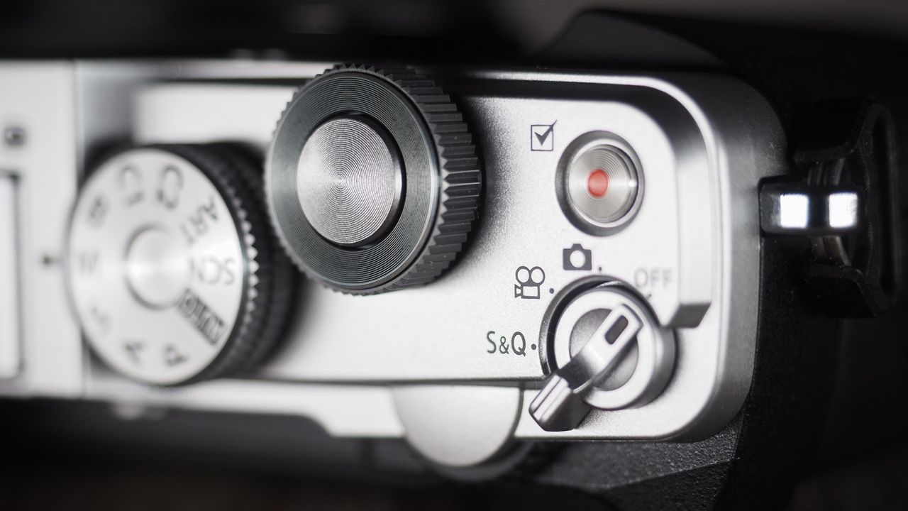 OM System OM-3 on a wooden surface