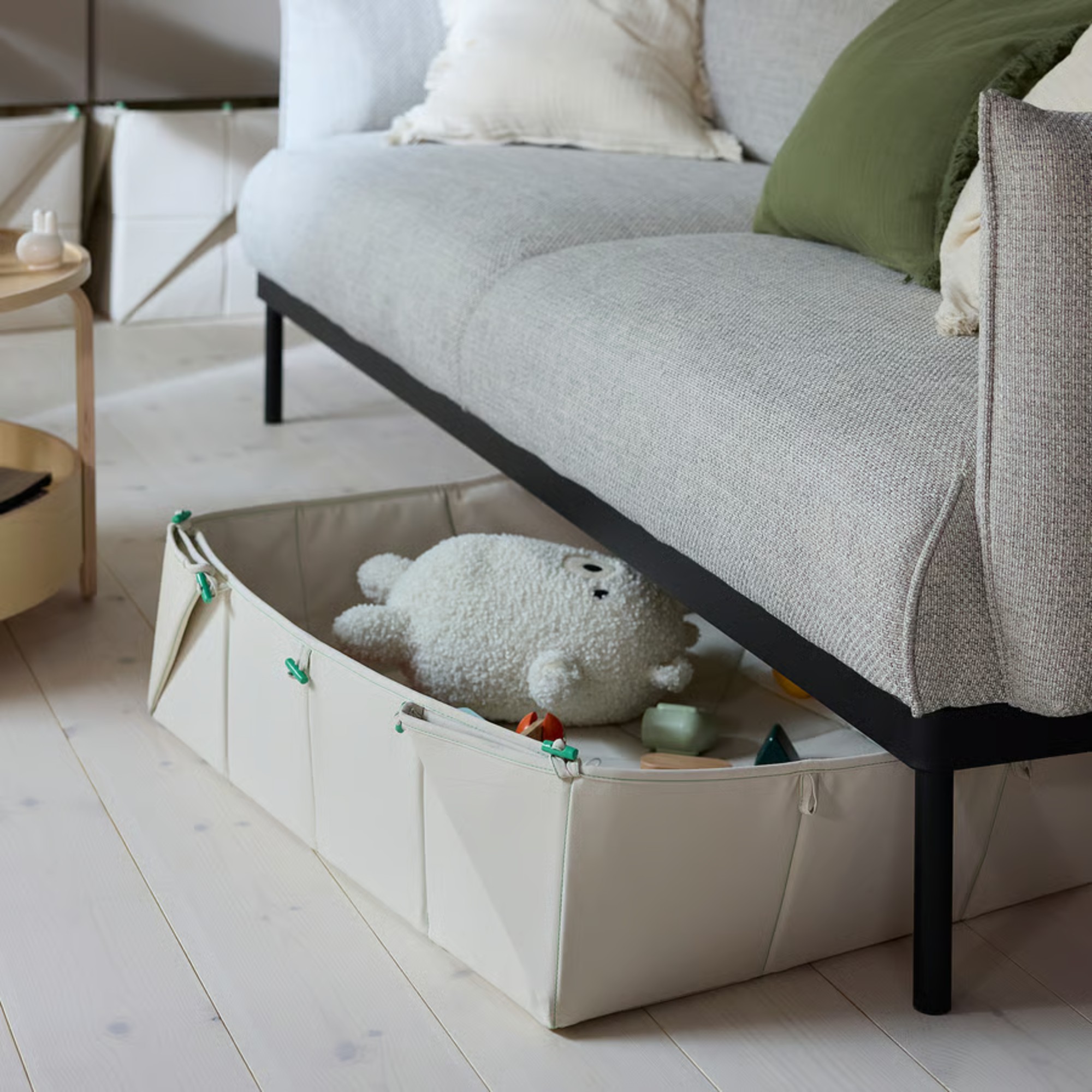 IKEA GREJSIMOJS foldable mat/toy storage box with toys inside slotted under a sofa