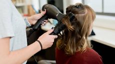 Woman getting her hair blow dried in a salon