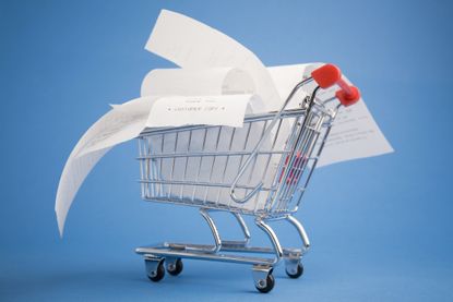 Grocery cart full of shopping receipts with a blue background