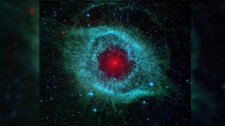 200 parsecs from Earth is the Helix Nebula. In this Spitzer space telescope image explosive blue /green clouds fo gas and dust radiate from a central red dwarf star