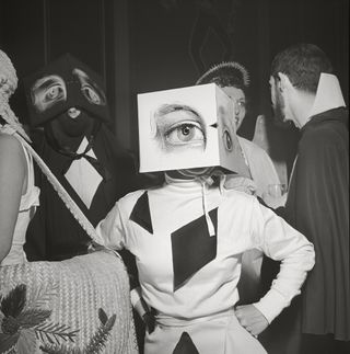 A black and white photograph, A partygoer wearing a Cubist headdress at Philadelphia’s first beaux-arts ball, 1949, captured by Stanley Kubrick