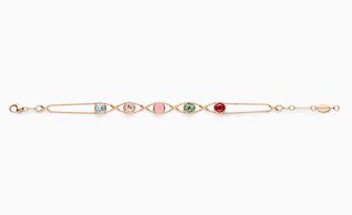 Gold necklace with five different coloured stones in
