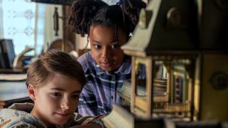 Bode Locke and Amie Bennett study a doll house in Locke and Key season 2