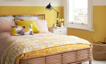 bedroom with sunshine yellow and white wall and sunshine yellow bedsheet 