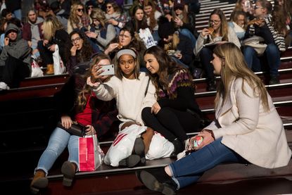 Teenagers take a photo in Times Square