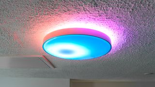 The Govee Ceiling Light Ultra installed on a ceiling and synced with music playing on a smart speaker nearby