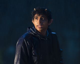 Grover Underwood (Aryan Simhadri) stands in the rain, soaking wet, his satyr horns visible through his hair