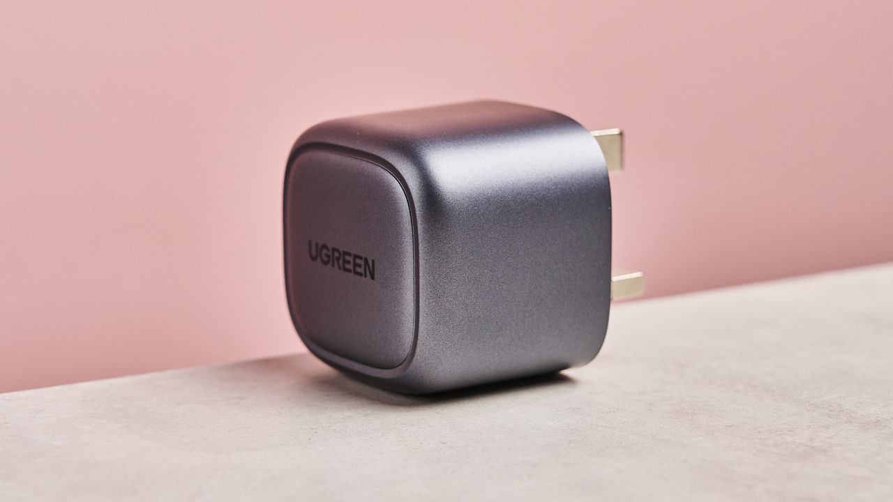 Side profile of the UGreen Nexode Mini 30W against pink background