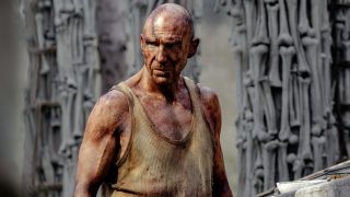 Ralph Fiennes stands in the bone temple with a look of curiosity in 28 Years Later.