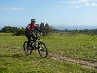 Cyclingnews tester Sue George riding the Nichol across Wilder Ranch trails in Santa Cruz, in view of the ocean.
