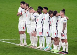 England’s Jadon Sancho and Bukayo Saka stand alongside their team-mates during the penalty shoot-out