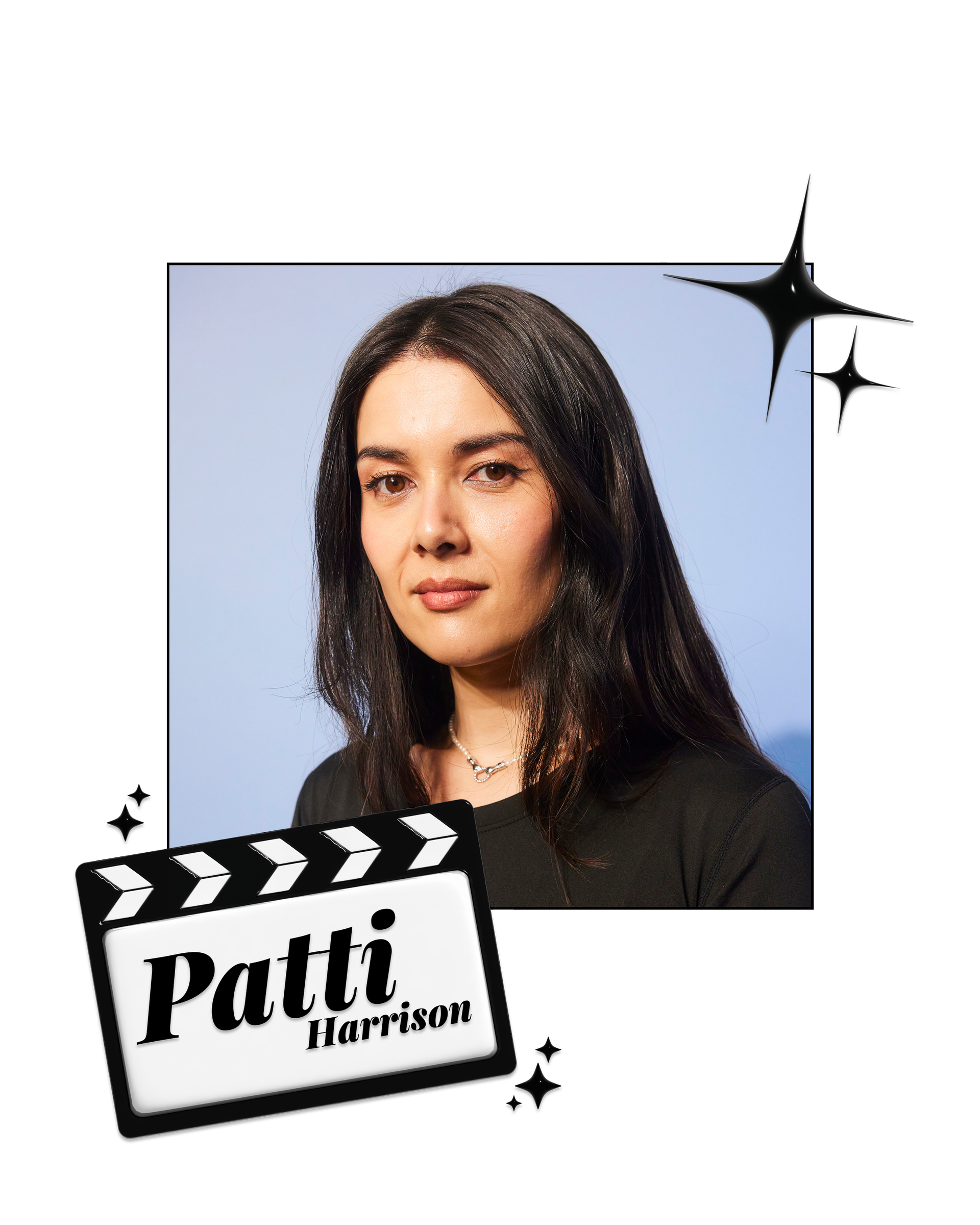 Patti Harrison in a black top in front of a blue wall