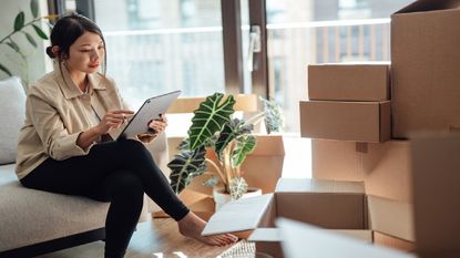 A young woman considers home insurance in her new home.