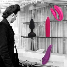 woman looking at storefront with different types of vibrators in the window