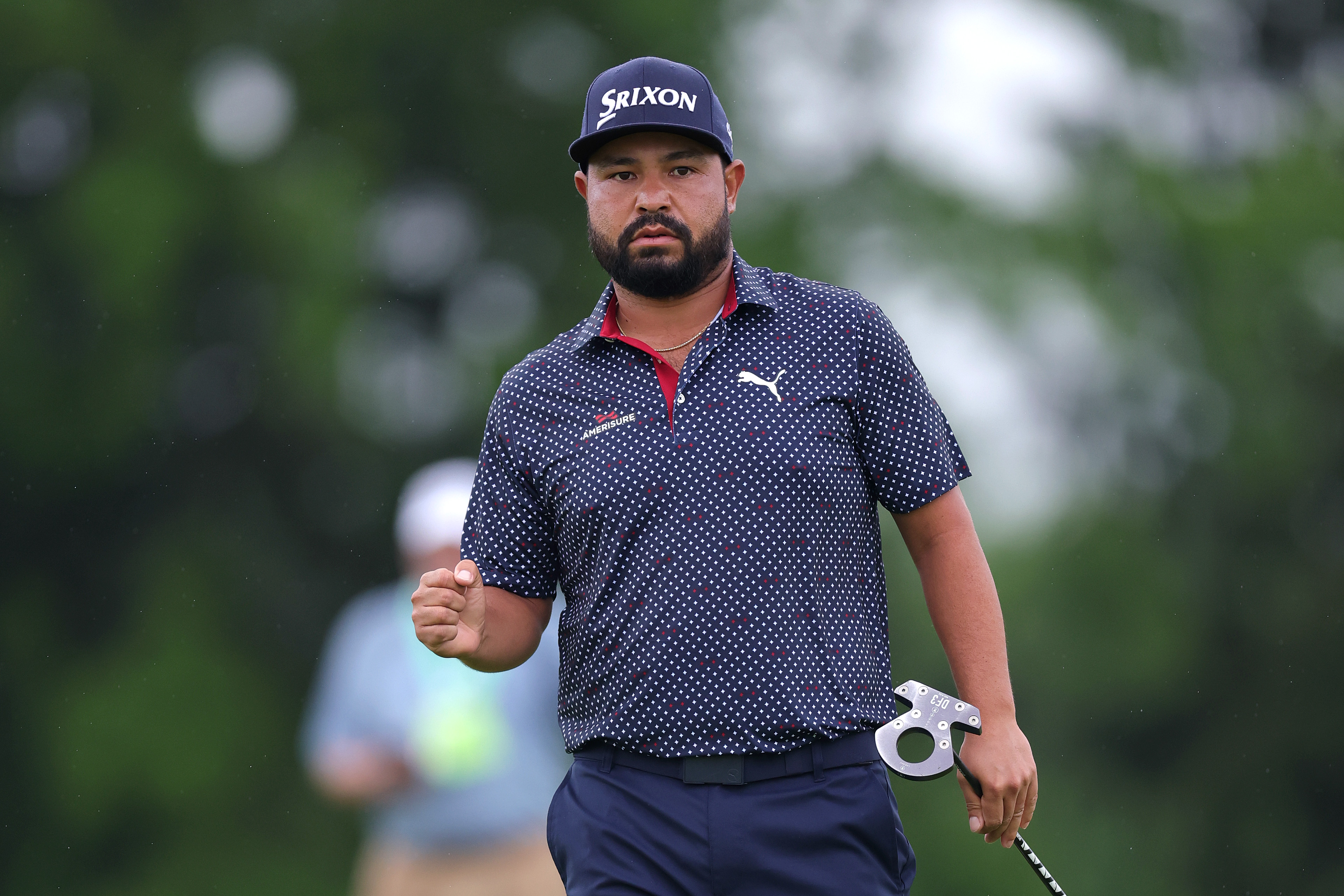 JJ Spaun fist pumps after holing a putt