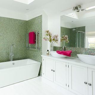 bathroom with white fixtures and green wall
