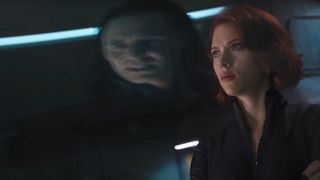 Tom Hiddleston appears as a distorted reflection in front of Scarlett Johansson in The Avengers.