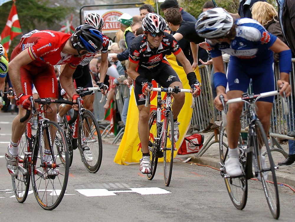 Igor Astarloza (L-Barloworld) and David Etxebarria (R-Liberty Seguros-Wurth team) look at their compatriot Alejandro Valverde (Caisse d'Epargne-Iles Baleares) during the 2006 Fleche Wallonne, a 202km ProTour event staged between Charleroi and Huy. The Iles Baleares rider edged out his compatriot Samuel Sanchez and Karsten Kroon of the Netherlands.