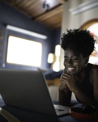 Woman smiling at her laptop