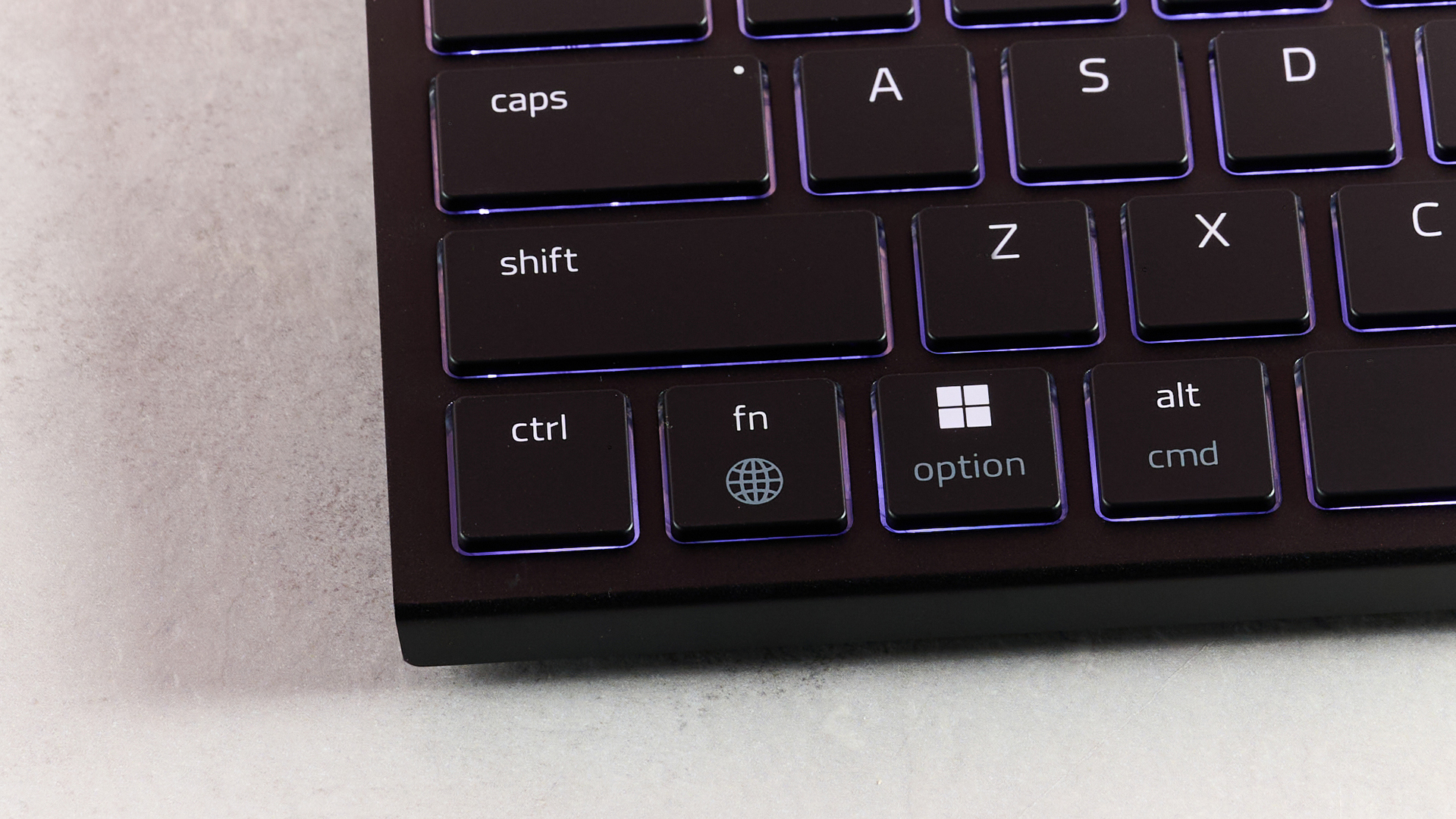 Close-up of bottom left corner of Razer Joro, on desk