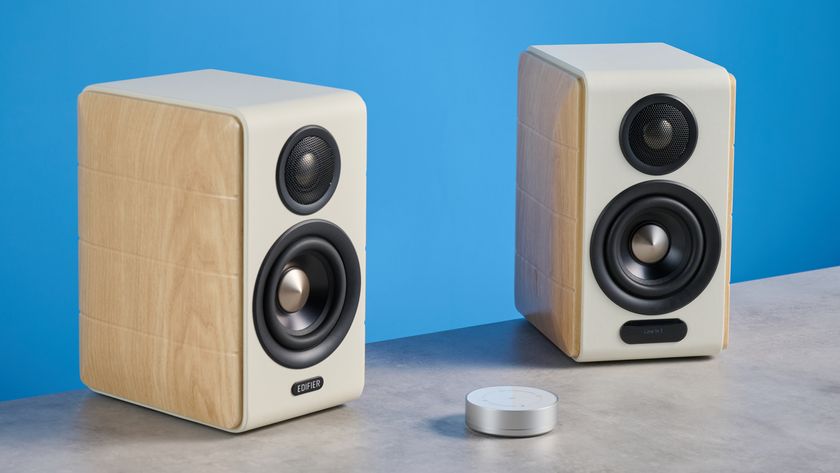 the edifier s880db mkii speakers in white and wood colorway showing the connectivity options, remote control, against a blue background
