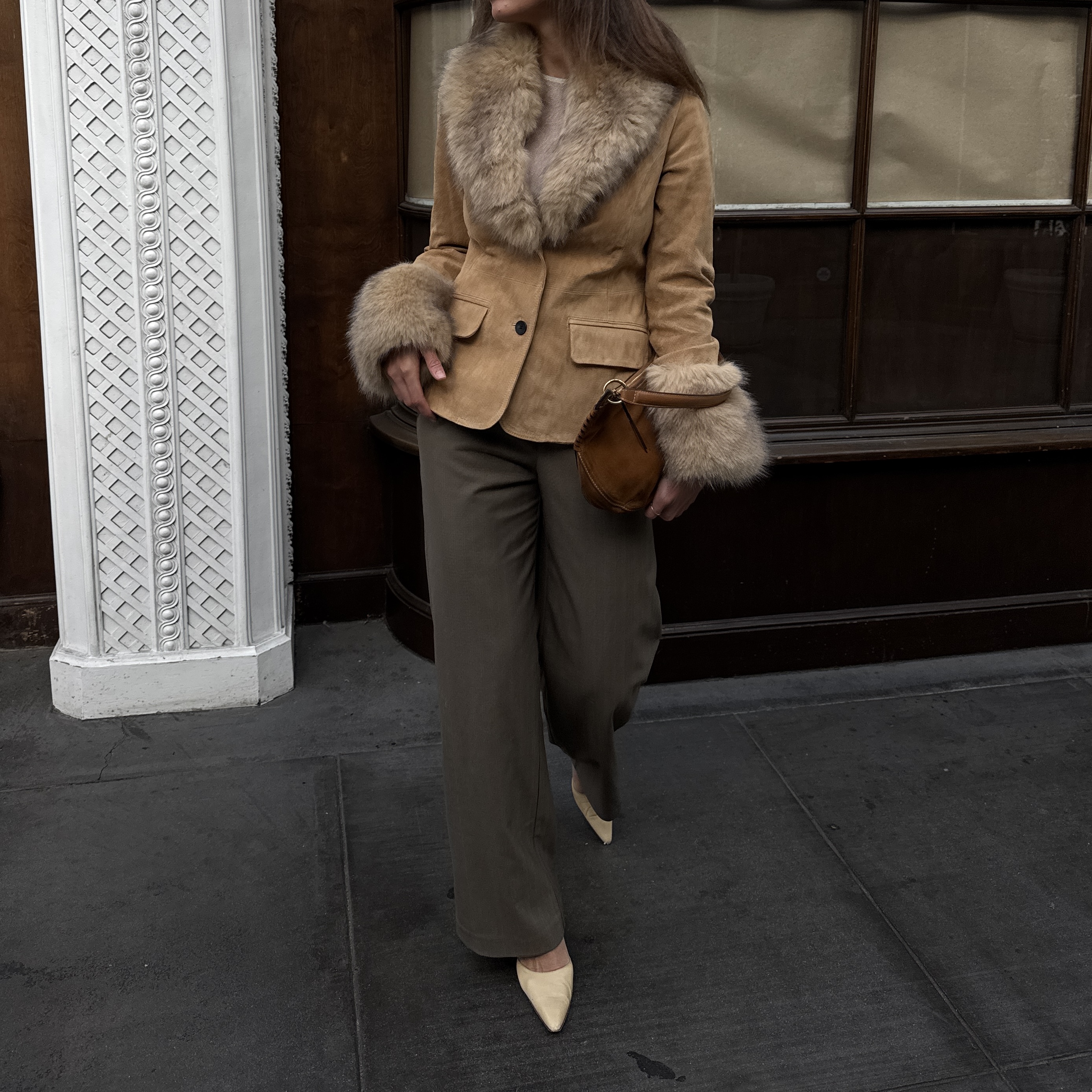 Kathryn Zahorak models a fur trim jacket, green pants, and suede bag
