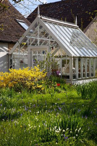 Traditionally made old style Victorian glass greenhouse in private garden.