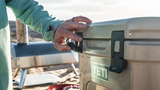 Person opening Yeti hard cooler