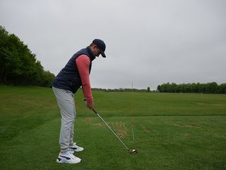 Golf Monthly Top 50 Coach Alex Elliott demonstrating an alignment drill to hit draw vs fade