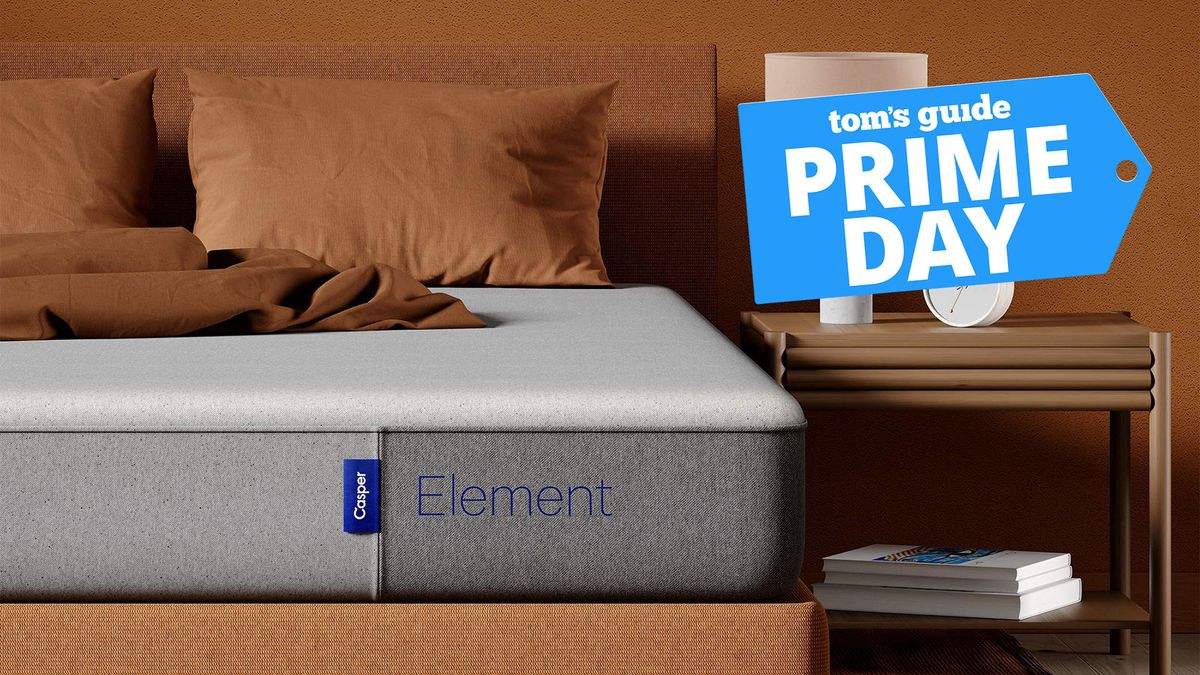 A close up of the corner of the Casper Sleep Element Mattress on a bed frame in a bedroom, a nightstand to the right with a lamp on top. A Tom&#039;s Guide Amazon Prime Day deals graphic (right)