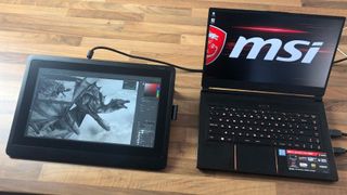 Wacom Cintiq 16 on a desk connected to an MSI laptop