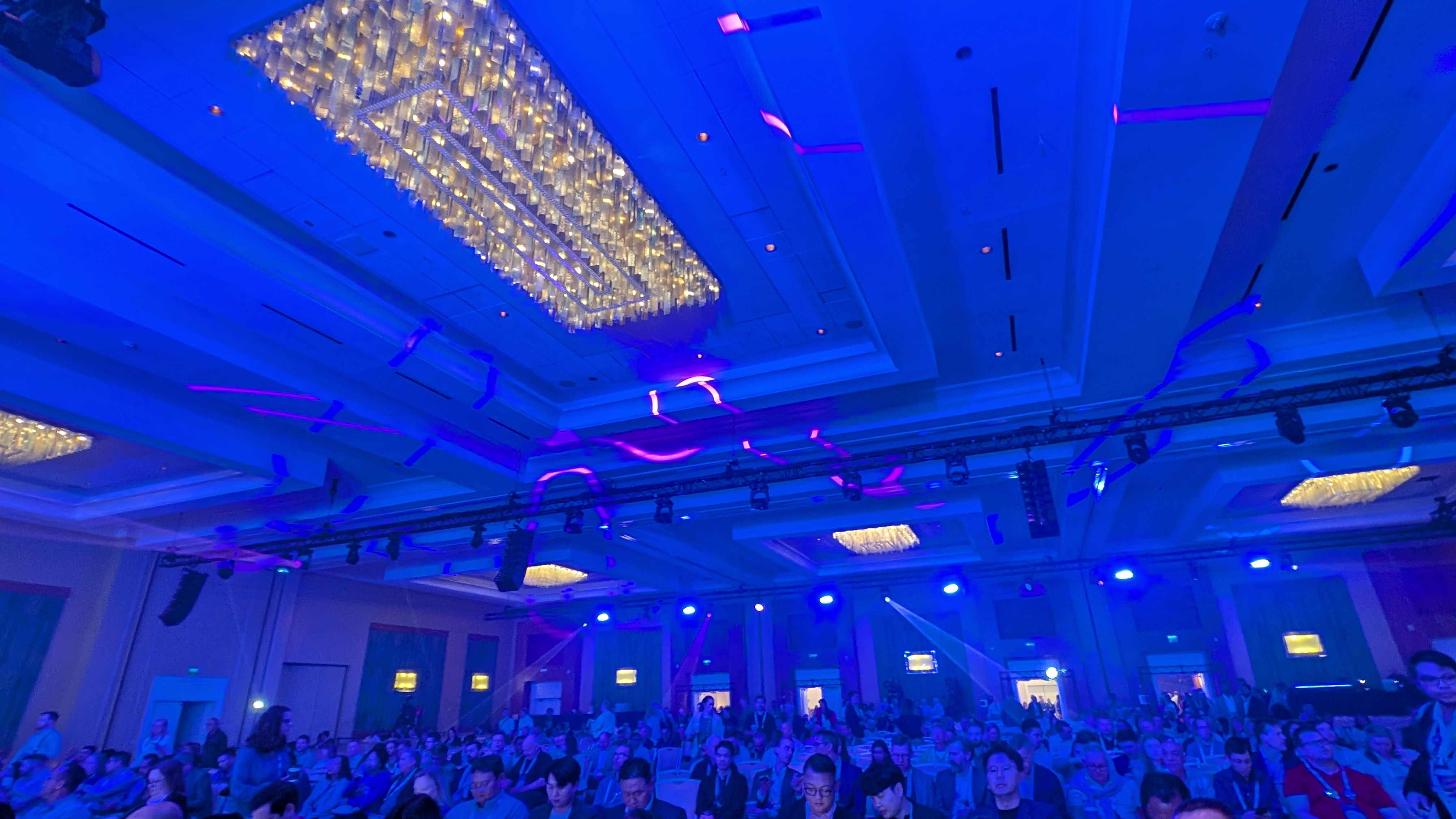 The SAS Innovate 2025 audience in the Orlando Ballroom at the Hilton Orlando, Florida. The crowd is bathed in blue light.
