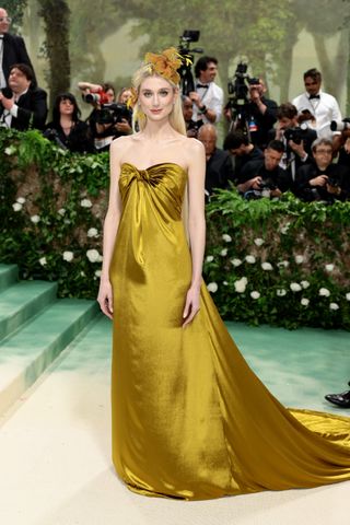 an actress in a yellow gown at the 2024 met gala
