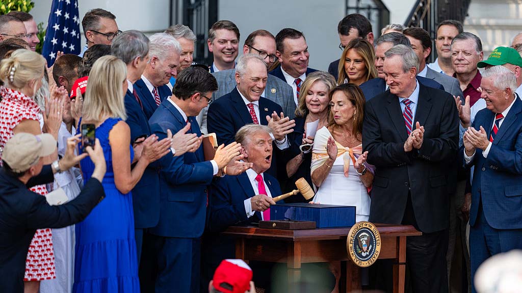 WASHINGTON, DC - JULY 04: U.S. President Donald Trump, joined by Republican lawmakers, holds a gavel after signing the &quot;One, Big Beautiful Bill&quot; Act into law during an Independence Day military family picnic on the South Lawn of the White House on July 04, 2025 in Washington, DC. After weeks of negotiations with Republican holdouts Congress passed the &quot;One, Big Beautiful Bill&quot; Act into law, President Trump&#039;s signature tax and spending bill. The bill makes permanent President Donald Trump&#039;s 2017 tax cuts, increase spending on defense and immigration enforcement and temporarily cut taxes on tips, while cutting funding for Medicaid, food assistance and other social safety net programs. (Photo by Eric Lee/Getty Images)