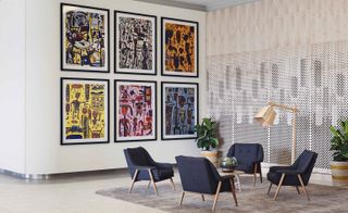 A beautiful paintings on a wall and armchairs at the Larwill Studio.
