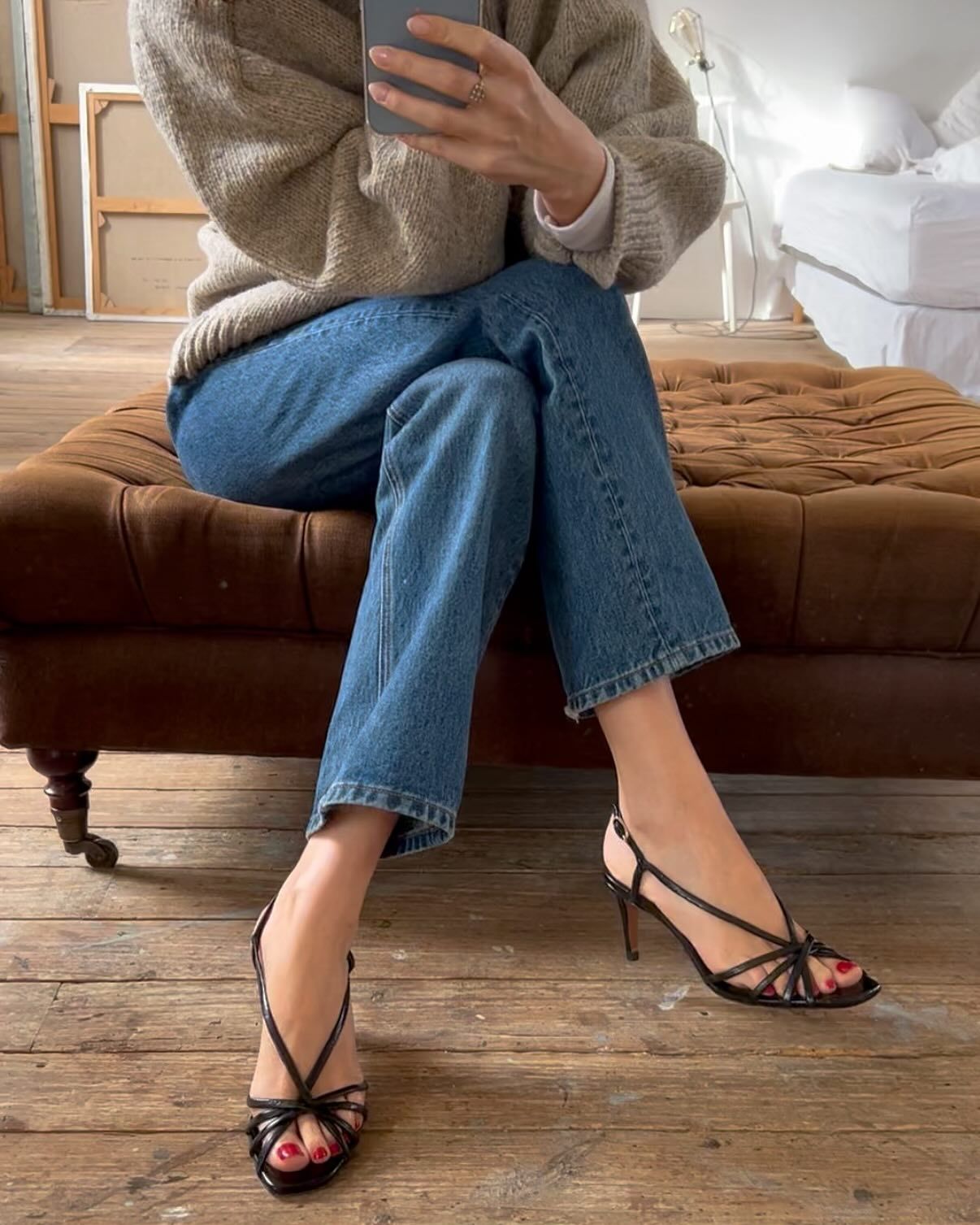 Woman in jeans and black strappy sandals