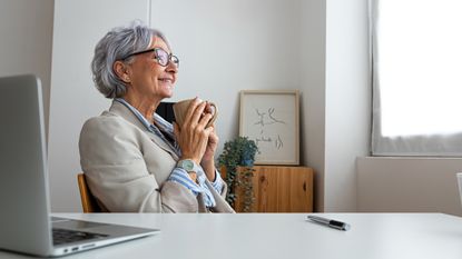 Businesswoman enjoying a coffee break in her office