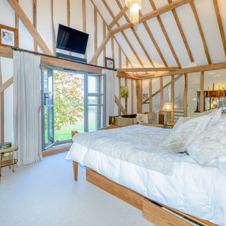 attic bedroom with wooden beams