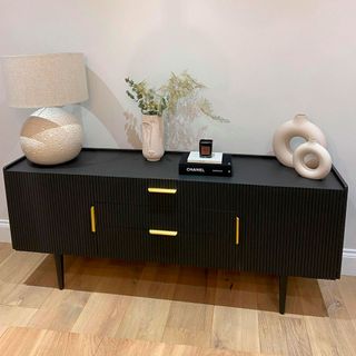 room with wooden flooring and black sideboard