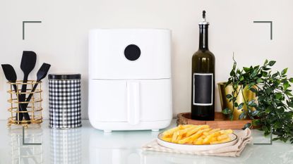 white kitchen with a white air fryer with a plat of cooked chips to ask are air fryers toxic
