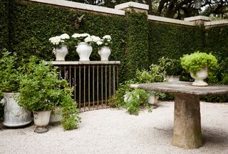Driveway with antique planters and stone table