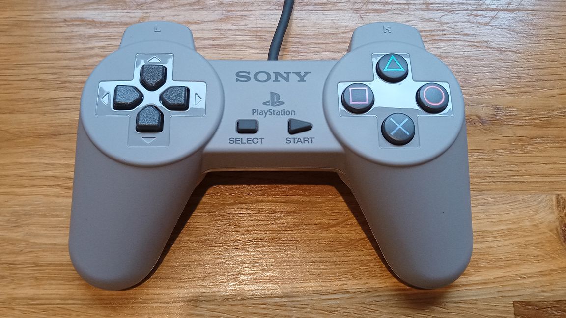 A photo of the PlayStation Classic Controller on a wooden table