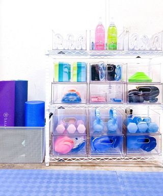 A set of modular clear storage cabinets with gym equipment