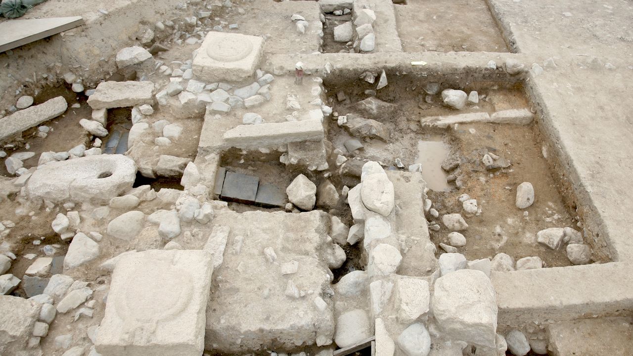 A view of an archaeological site with multiple rooms and stone blocks