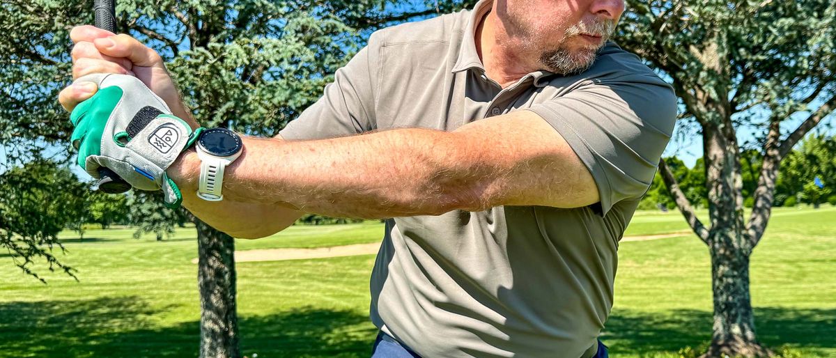 Man playing golf while wearing the Lululemon ShowZero polo outside