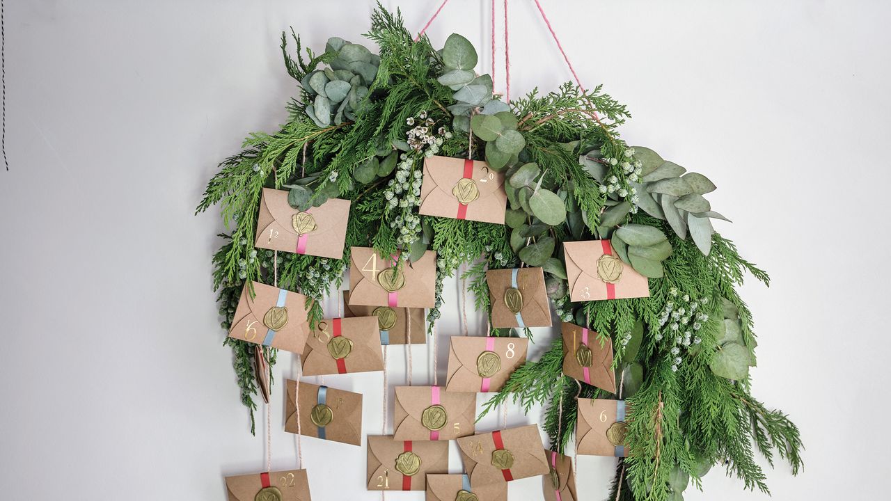 Homemade advent calendar made up of envelopes and foliage