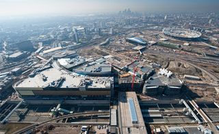 An aerial view of Westfield Stratford City and surrounding Olympic village, showing a render of the pavilion to the right.